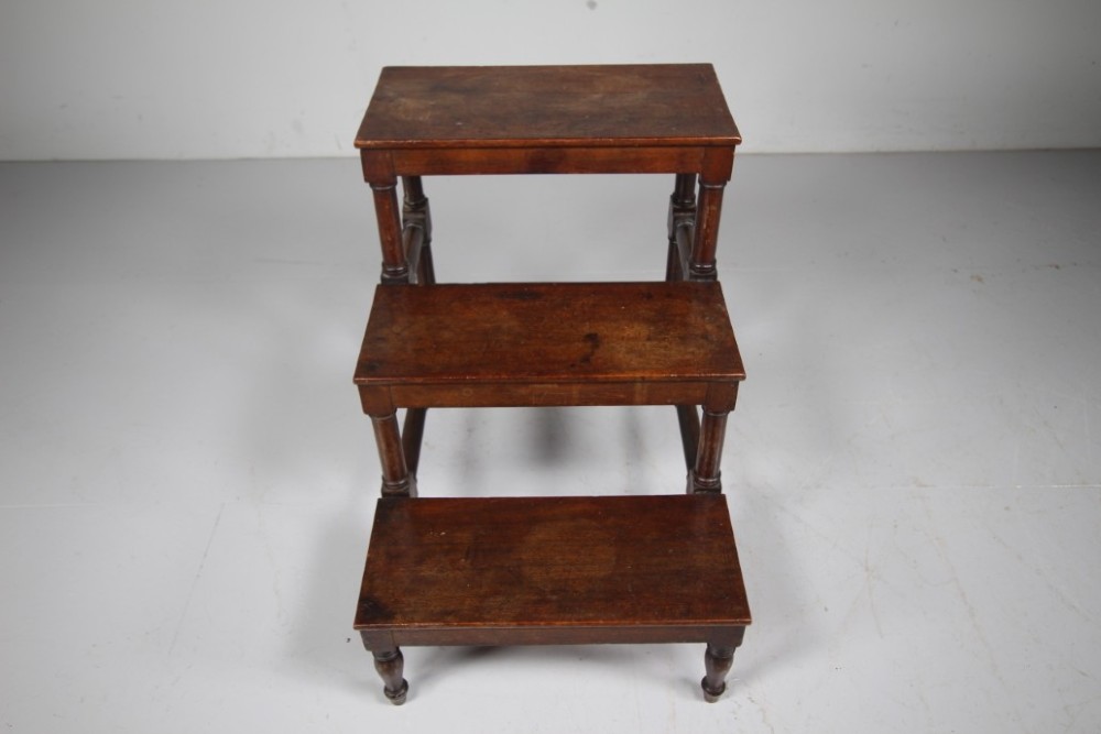 A three-tiered set of 19th-century dark mahogany library steps featuring turned legs and supporting stretchers. View III