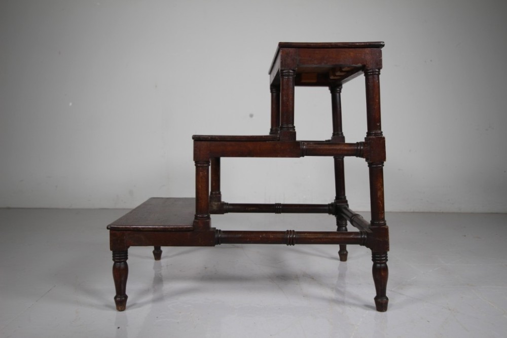 A three-tiered set of 19th-century dark mahogany library steps featuring turned legs and supporting stretchers. View V