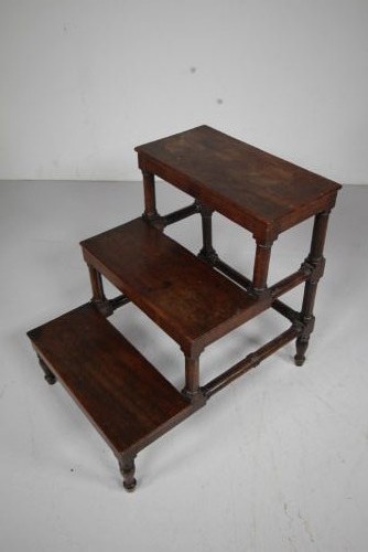 A three-tiered set of 19th-century dark mahogany library steps featuring turned legs and supporting stretchers.