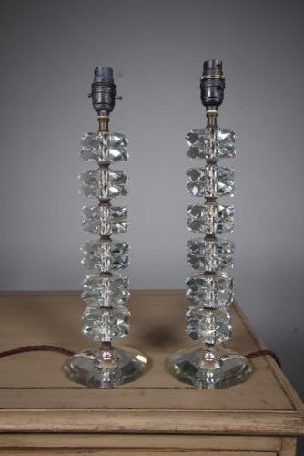 A pair of 1920s English cut glass table lamps featuring stacked faceted glass elements on round cut bases with dark metal lamp holders. View III