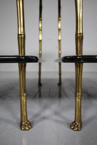 A pair of mid-century two-tier side tables with brass simulated bamboo legs and brown patterned lacquered surfaces topped with pinecone finials. View X