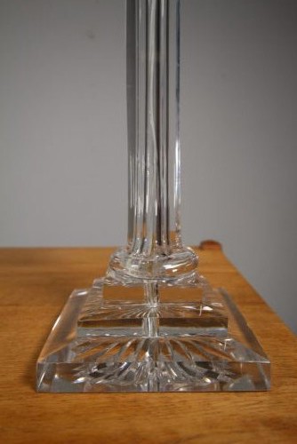 A tall 19th-century clear cut-glass table lamp featuring a fluted column, stepped square base, and an ornate gilt brass Corinthian capital. View II