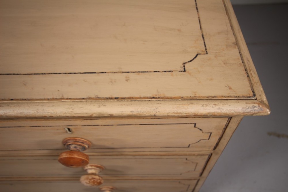 A Georgian painted pine chest of drawers featuring two short over three long drawers with turned knobs and hand-painted line borders. View V