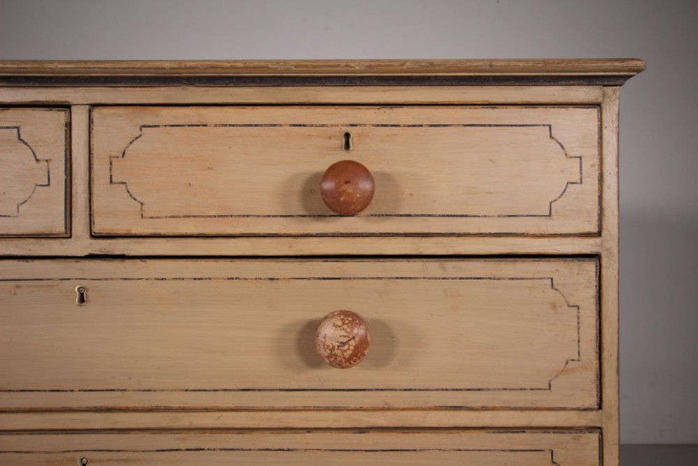 A Georgian painted pine chest of drawers featuring two short over three long drawers with turned knobs and hand-painted line borders. View VI
