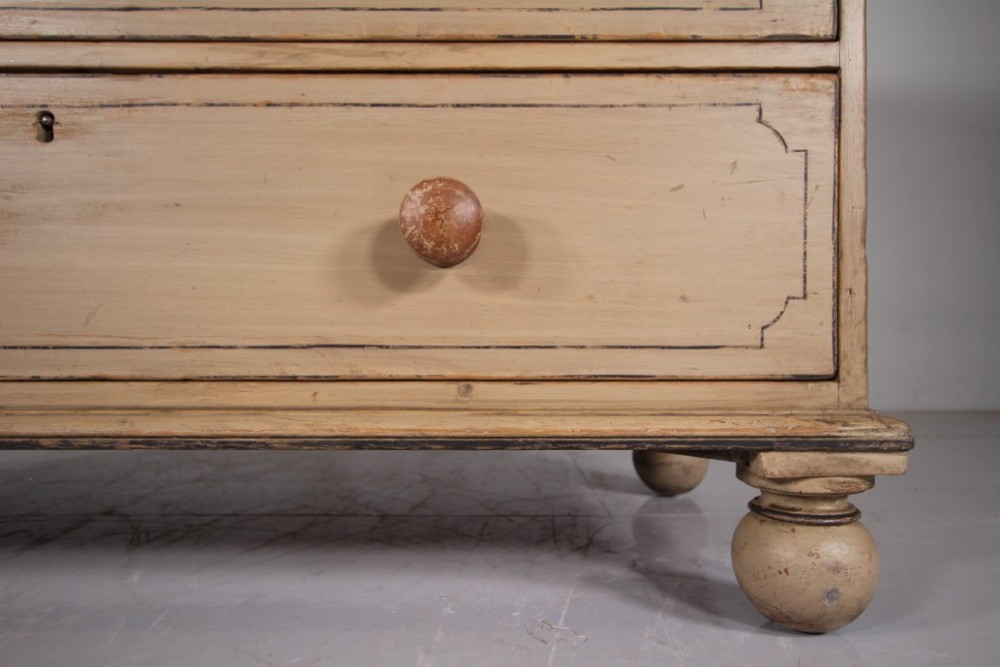 A Georgian painted pine chest of drawers featuring two short over three long drawers with turned knobs and hand-painted line borders. View VII