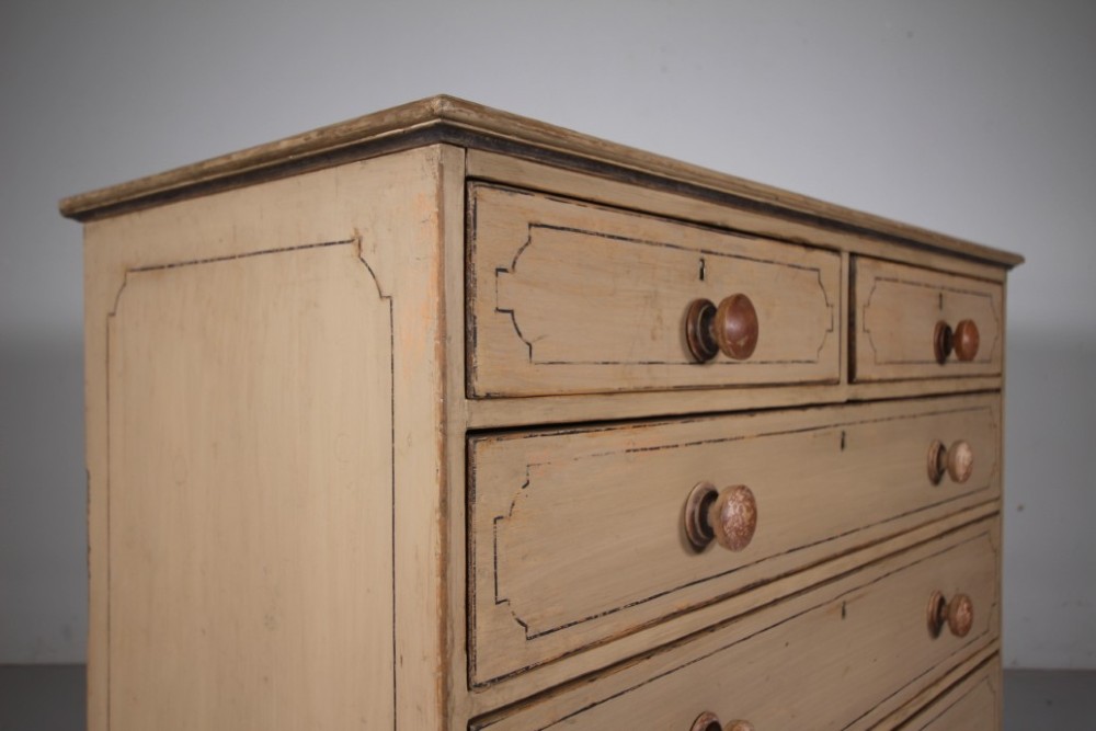 A Georgian painted pine chest of drawers featuring two short over three long drawers with turned knobs and hand-painted line borders. View IX