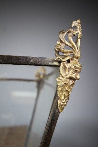 An 18th-century hanging hall lantern featuring a tapered clear glass body, dark bronze frame, detailed gilt bronze corner mounts, and suspension chains. View V