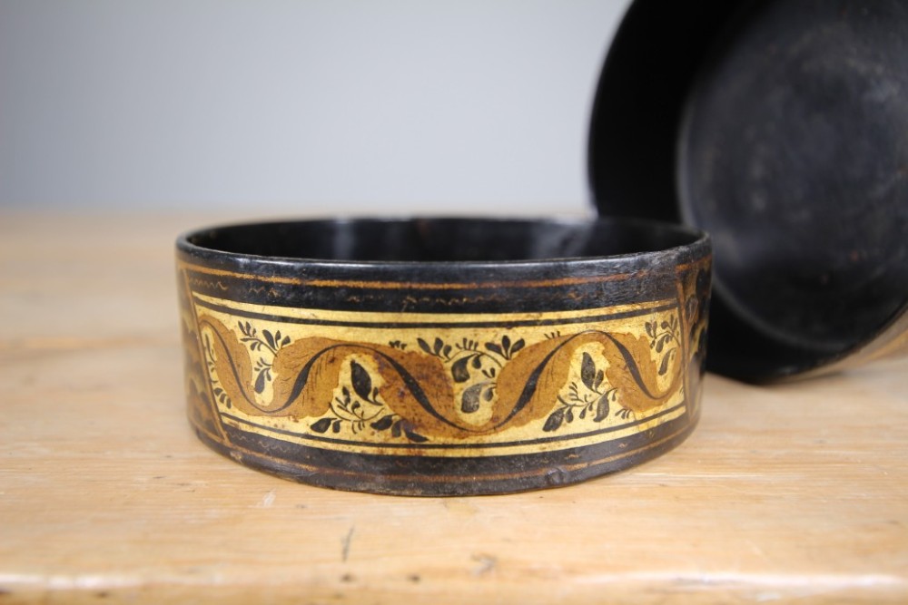 A pair of circular Regency black japanned wine coasters decorated with gilded leaf motifs and scrolling foliage. View VI