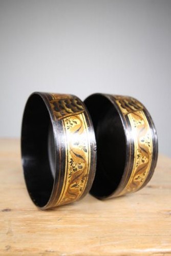 A pair of circular Regency black japanned wine coasters decorated with gilded leaf motifs and scrolling foliage. View V