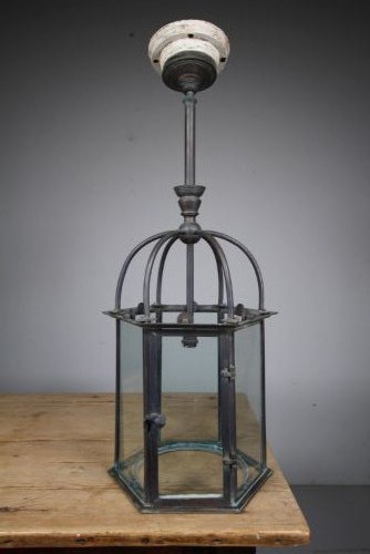 A 19th-century dark bronze hexagonal hallway lantern featuring glazed glass side panels, a domed cage top, and a central hanging stem.