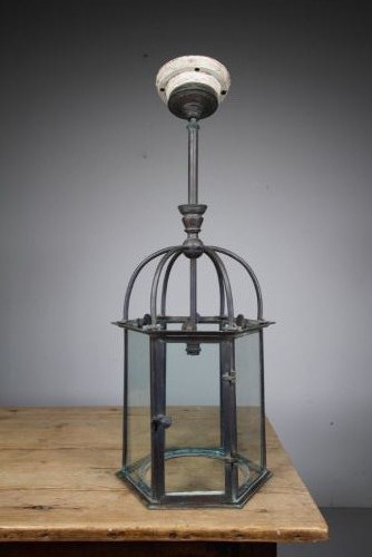A 19th-century dark bronze hexagonal hallway lantern featuring glazed glass side panels, a domed cage top, and a central hanging stem. View IX