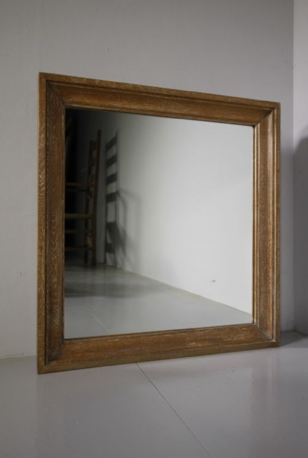 A large 1920s rectangular wall mirror featuring a wide moulded oak frame with natural wood grain.