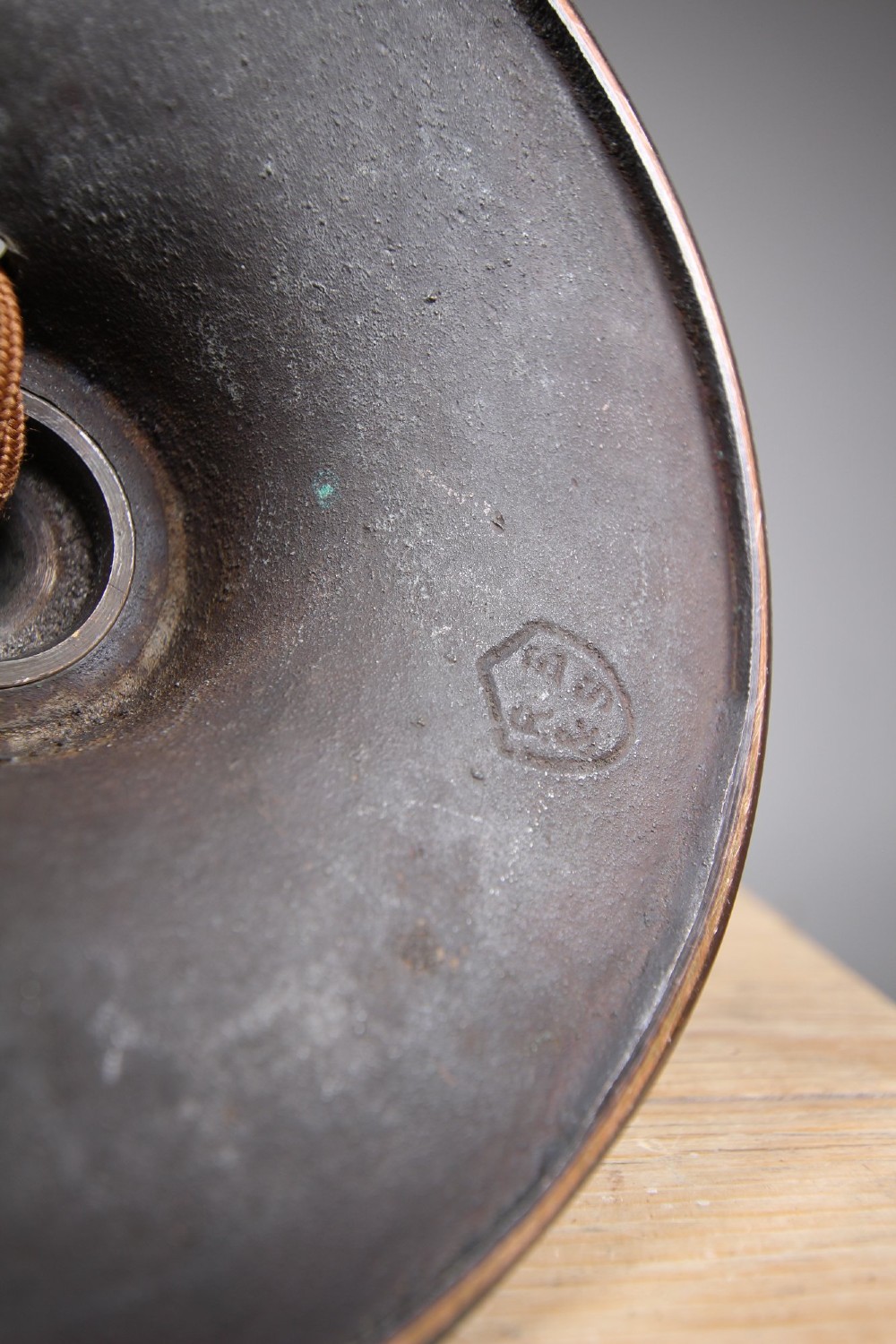 An antique coppered metal table lamp base featuring a turned baluster stem, a stepped circular foot, and a brass bulb fitting. View III