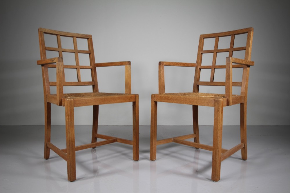 A set of six light oak dining chairs featuring geometric lattice backrests and woven seats, including two carvers with armrests. View IV