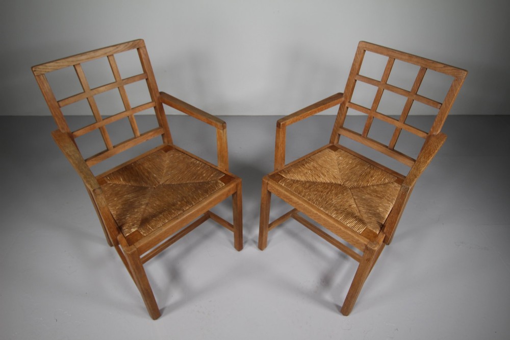 A set of six light oak dining chairs featuring geometric lattice backrests and woven seats, including two carvers with armrests. View V