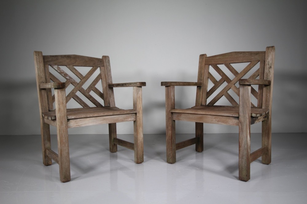 A set of four weathered teak garden armchairs with geometric Chinese Chippendale lattice backrests and square legs. View III