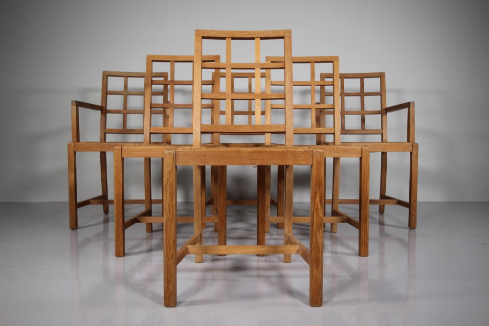 A set of six light oak 1920s dining chairs featuring geometric lattice backs, straight legs, and woven seats. View VIII