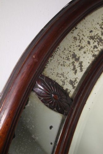 A large 19th-century oval mahogany wall mirror featuring a double-banded wooden frame with segmented antiqued glass borders. View II