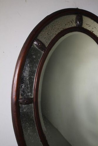 A large 19th-century oval mahogany wall mirror featuring a double-banded wooden frame with segmented antiqued glass borders. View V