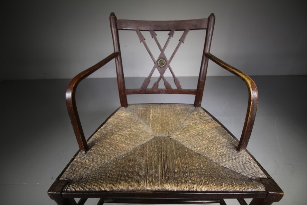 A dark brown painted Georgian Yealmpton armchair featuring a woven rush seat and an X-frame back splat. View VII