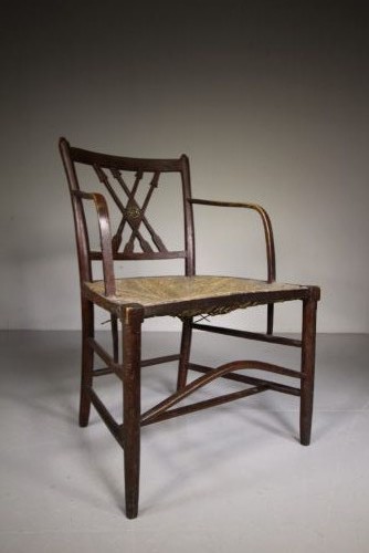 A dark brown painted Georgian Yealmpton armchair featuring a woven rush seat and an X-frame back splat. View II