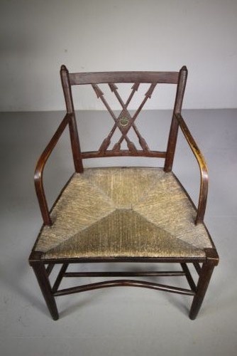 A dark brown painted Georgian Yealmpton armchair featuring a woven rush seat and an X-frame back splat. View V