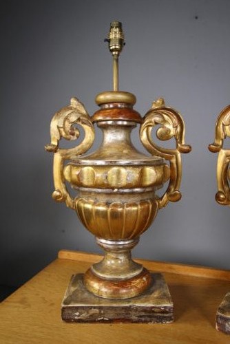 A pair of 19th-century carved pine urn table lamps with distressed gold leaf finish, scrolled handles, and square plinth bases. View IV
