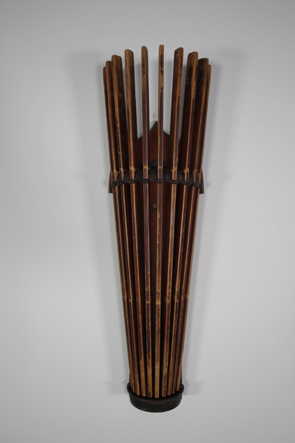 An antique wall-mounted wooden clothes dryer featuring multiple moveable laths fanning out from a central dark wood backplate. View III