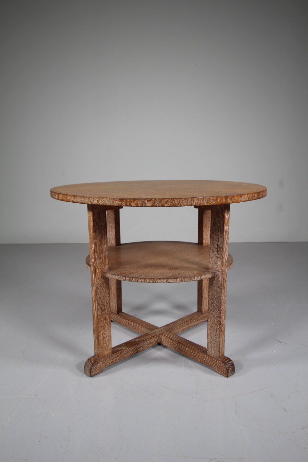 A circular oak two-tier side table featuring straight square legs and an X-frame base stretcher. View III