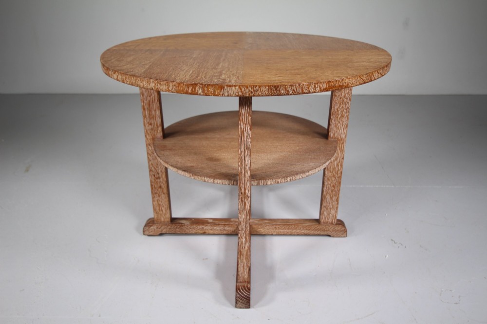 A circular oak two-tier side table featuring straight square legs and an X-frame base stretcher. View V