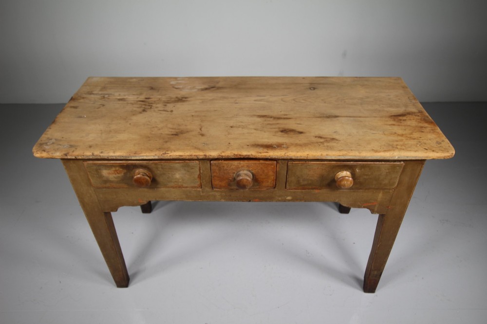 An 18th-century English painted pine serving table featuring three drawers with wooden handles, a shaped apron, and tapered square legs. View II