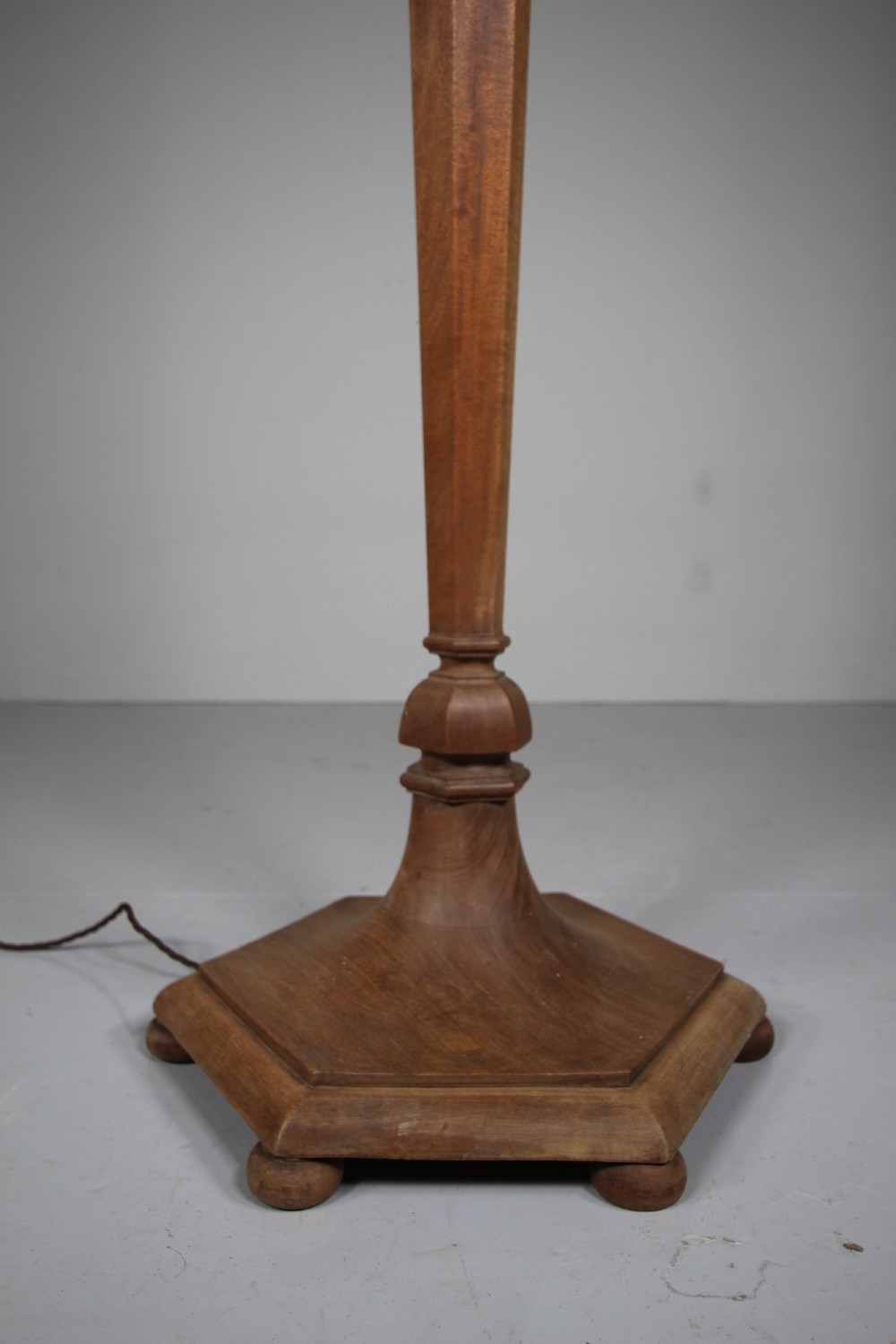 A 1930s turned walnut floor lamp featuring a tapered column resting on a moulded hexagonal base with bun feet. View III