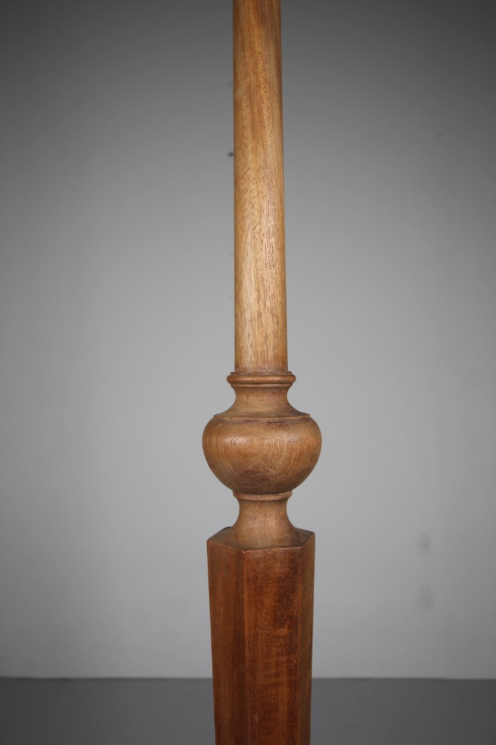 A 1930s turned walnut floor lamp featuring a tapered column resting on a moulded hexagonal base with bun feet. View IV