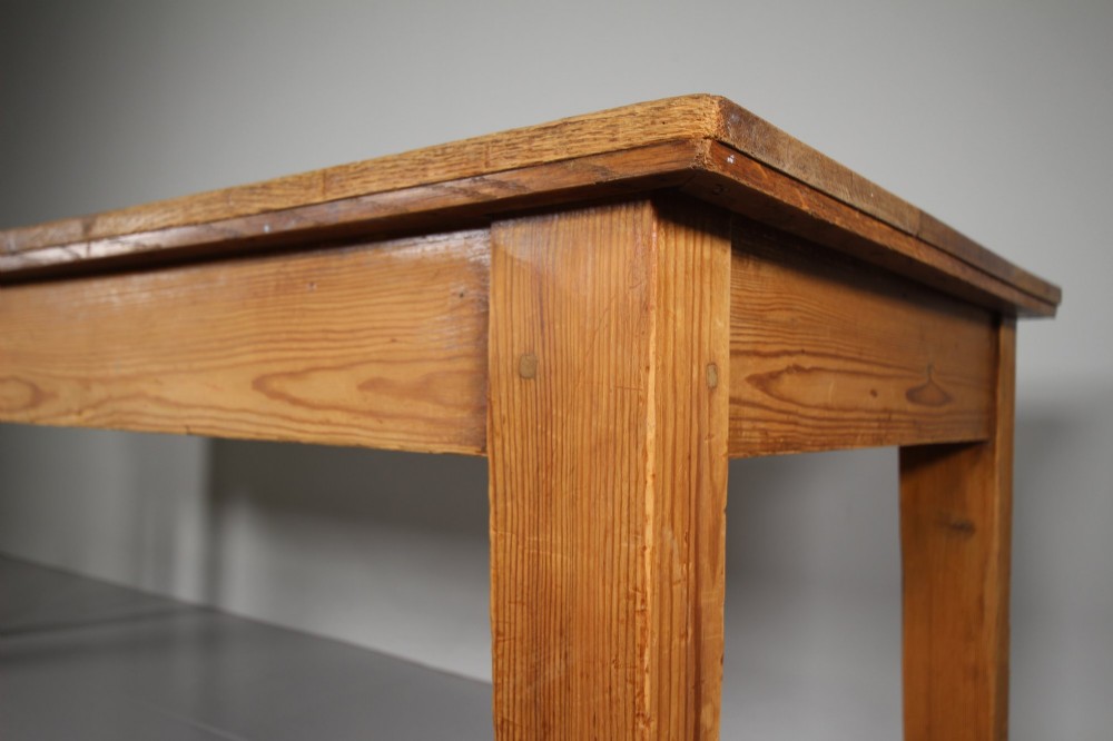 A large 19th-century English pine dining table featuring a solid plank top and four simple square legs. View II