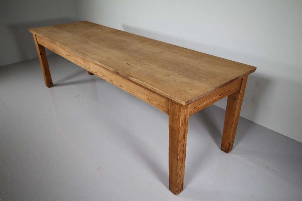 A large 19th-century English pine dining table featuring a solid plank top and four simple square legs. View III