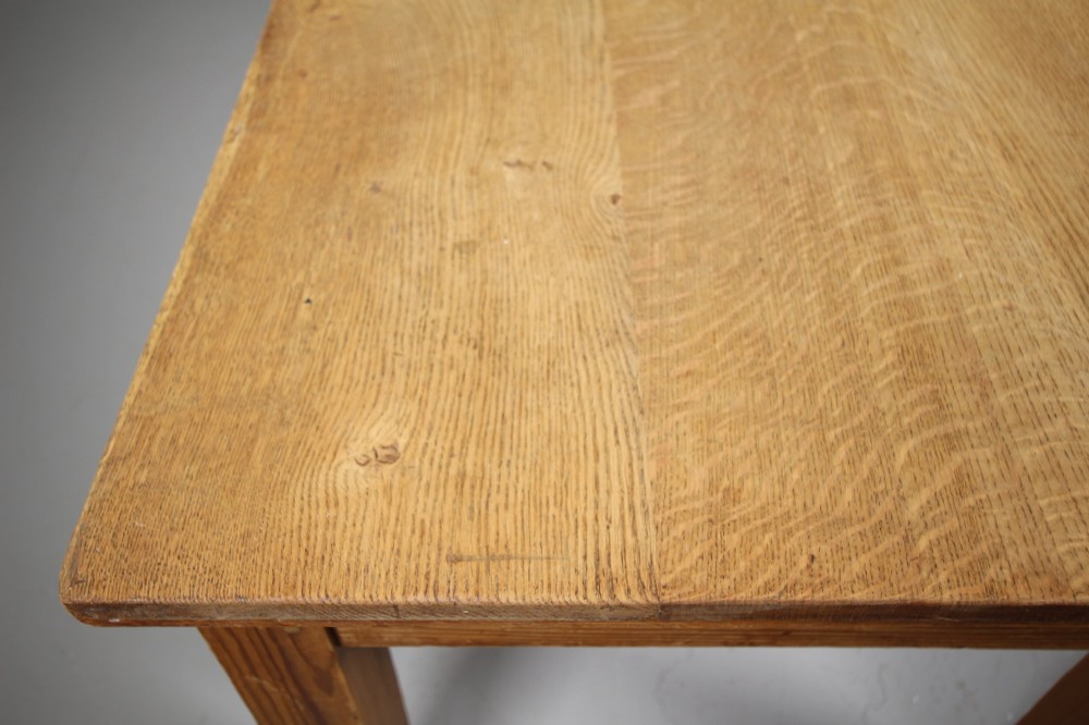 A large 19th-century English pine dining table featuring a solid plank top and four simple square legs. View V