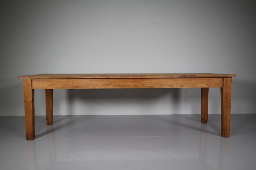 A large 19th-century English pine dining table featuring a solid plank top and four simple square legs. View VII
