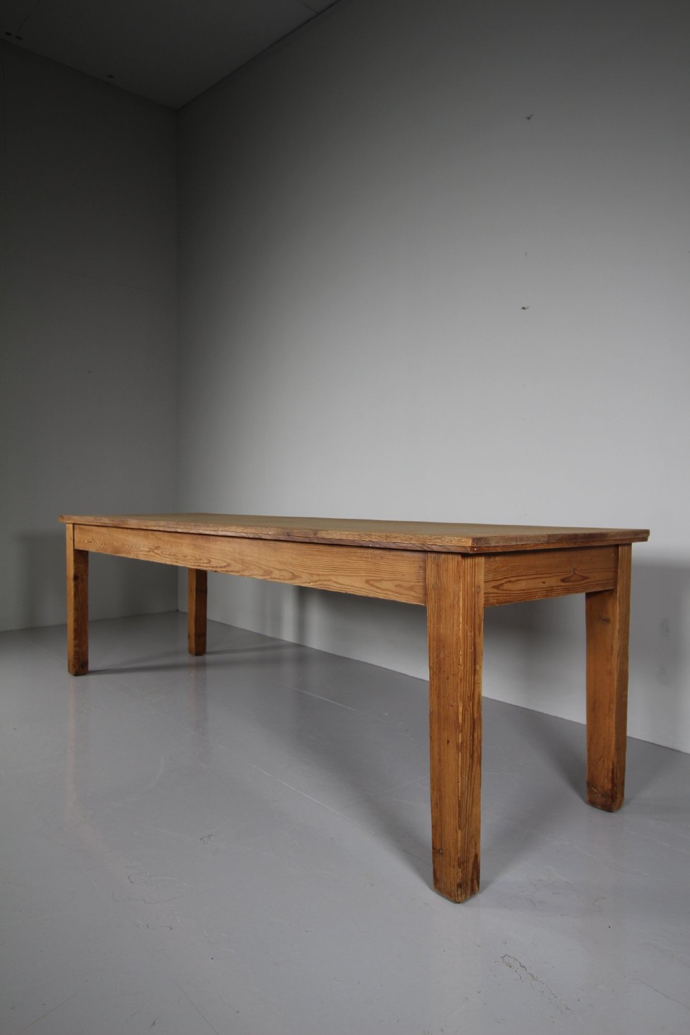 A large 19th-century English pine dining table featuring a solid plank top and four simple square legs. View VIII