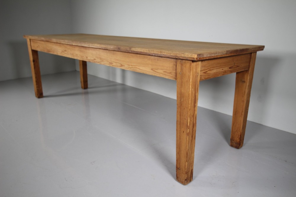 A large 19th-century English pine dining table featuring a solid plank top and four simple square legs. View IX