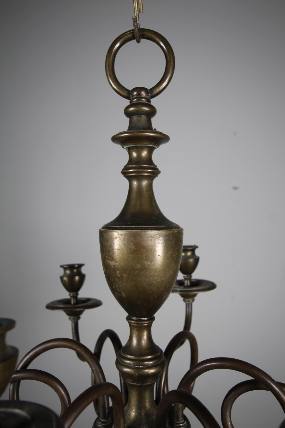 A 19th-century cast bronze six-arm chandelier featuring a central turned baluster stem, scrolled branches, and candle sconces. View II