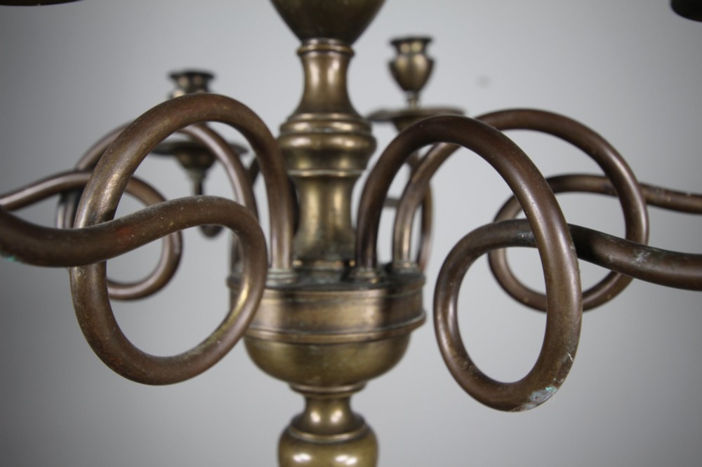 A 19th-century cast bronze six-arm chandelier featuring a central turned baluster stem, scrolled branches, and candle sconces. View IV