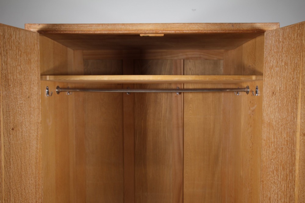 A tall light oak two-door wardrobe featuring octagonal upper panels, quarter-sawn wood grain, and small turned knobs on a plinth base. View II