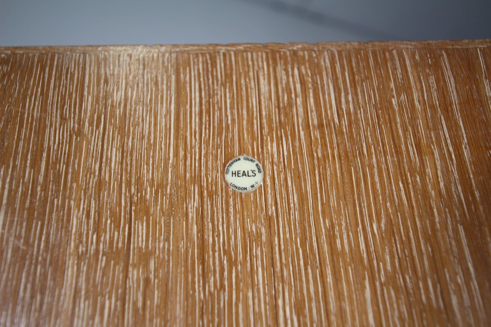 A tall light oak two-door wardrobe featuring octagonal upper panels, quarter-sawn wood grain, and small turned knobs on a plinth base. View III