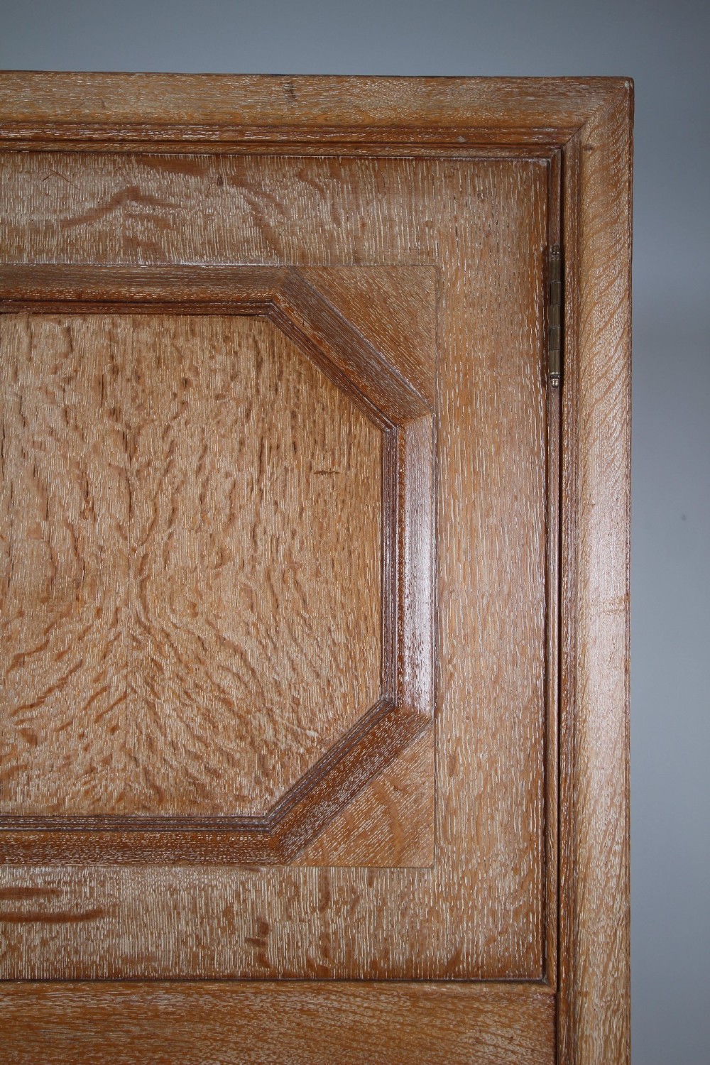 A tall light oak two-door wardrobe featuring octagonal upper panels, quarter-sawn wood grain, and small turned knobs on a plinth base. View VIII