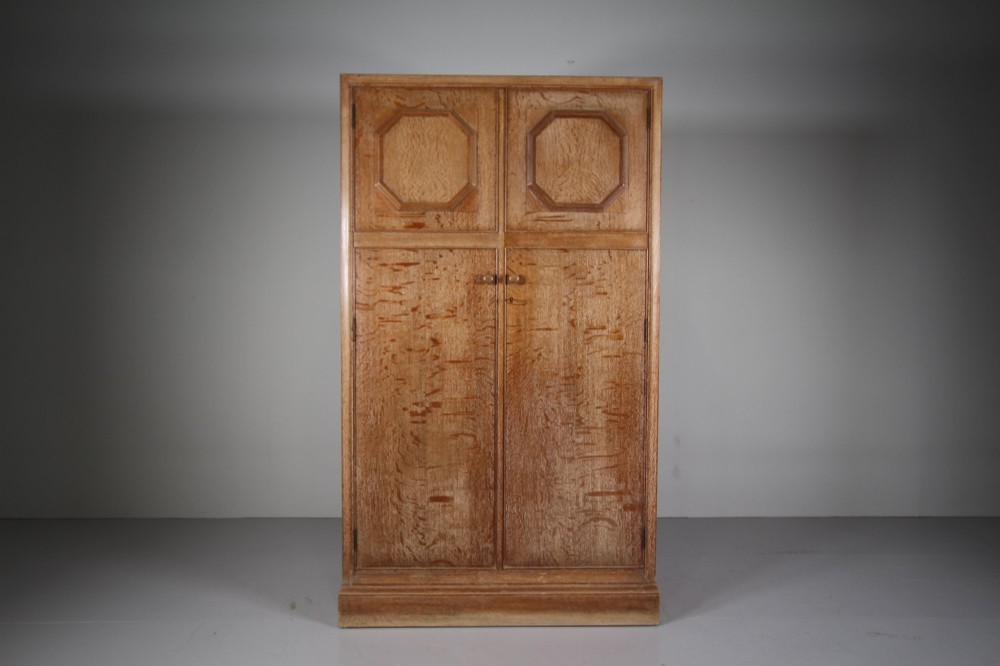 A tall light oak two-door wardrobe featuring octagonal upper panels, quarter-sawn wood grain, and small turned knobs on a plinth base. View IX