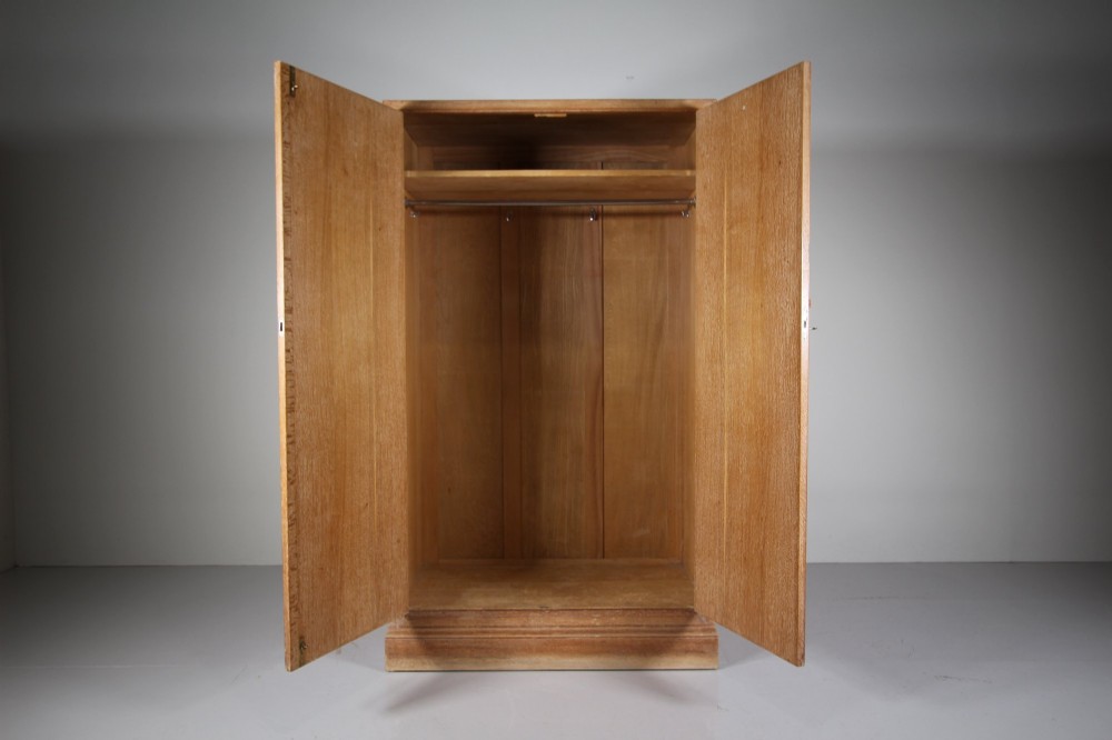 A tall light oak two-door wardrobe featuring octagonal upper panels, quarter-sawn wood grain, and small turned knobs on a plinth base. View X