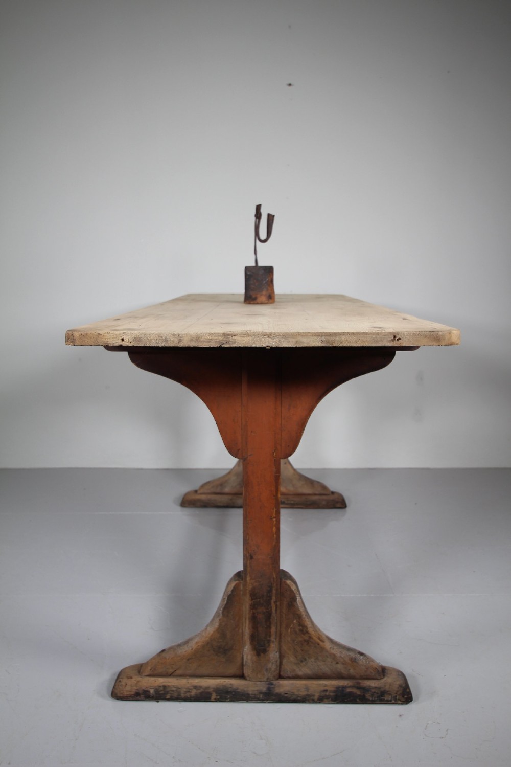 An antique 19th-century English tavern table featuring a scrubbed pine top resting on a red painted trestle base with a central stretcher. View II