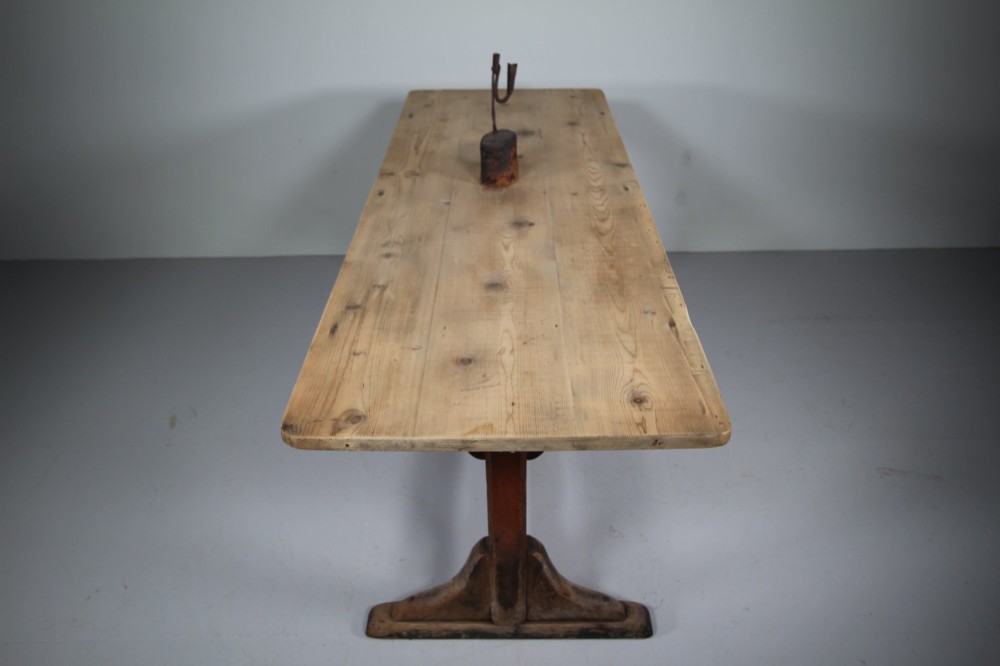 An antique 19th-century English tavern table featuring a scrubbed pine top resting on a red painted trestle base with a central stretcher. View III