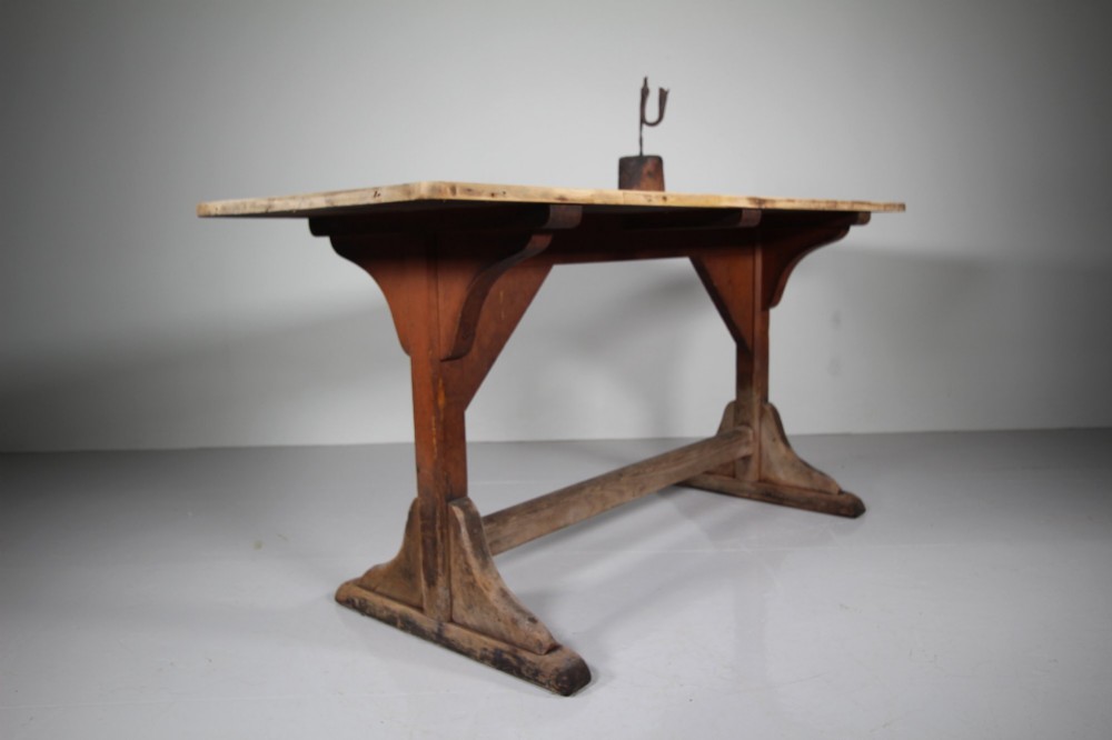 An antique 19th-century English tavern table featuring a scrubbed pine top resting on a red painted trestle base with a central stretcher. View VI