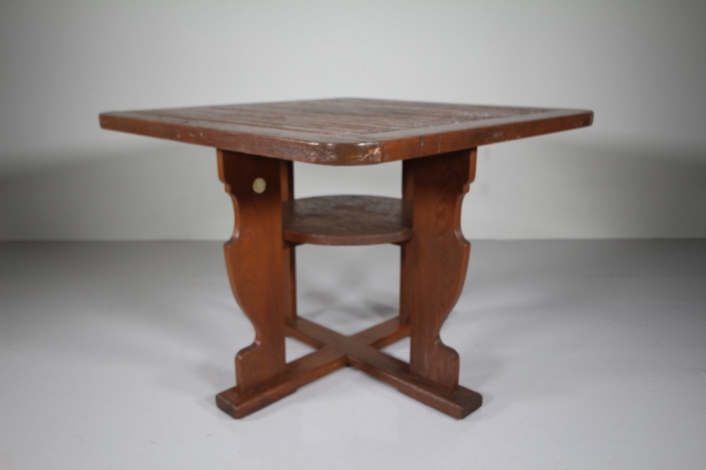 A 1920s slatted teak garden dining set featuring a square table and four corner chairs that tuck flush under the tabletop. View III